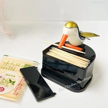 Dispenser automático de palillos con diseño de pajarito. 